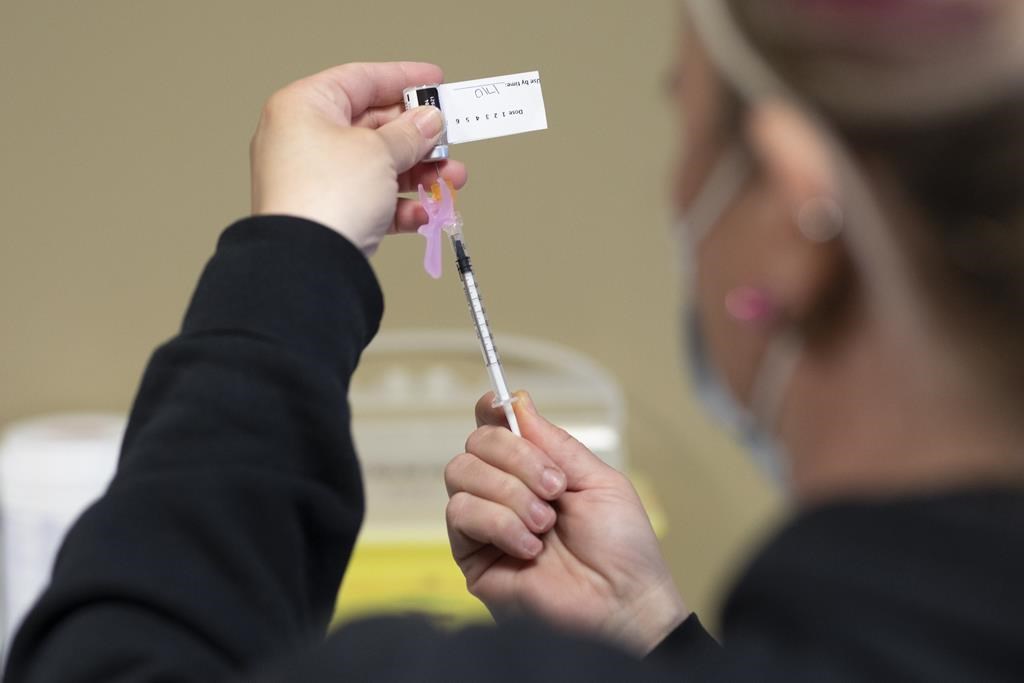 A RN draws the vaccine into a syringe at the Saskatoon Tribal Council run vaccination clinic inside SaskTel Centre on April 15, 2021.