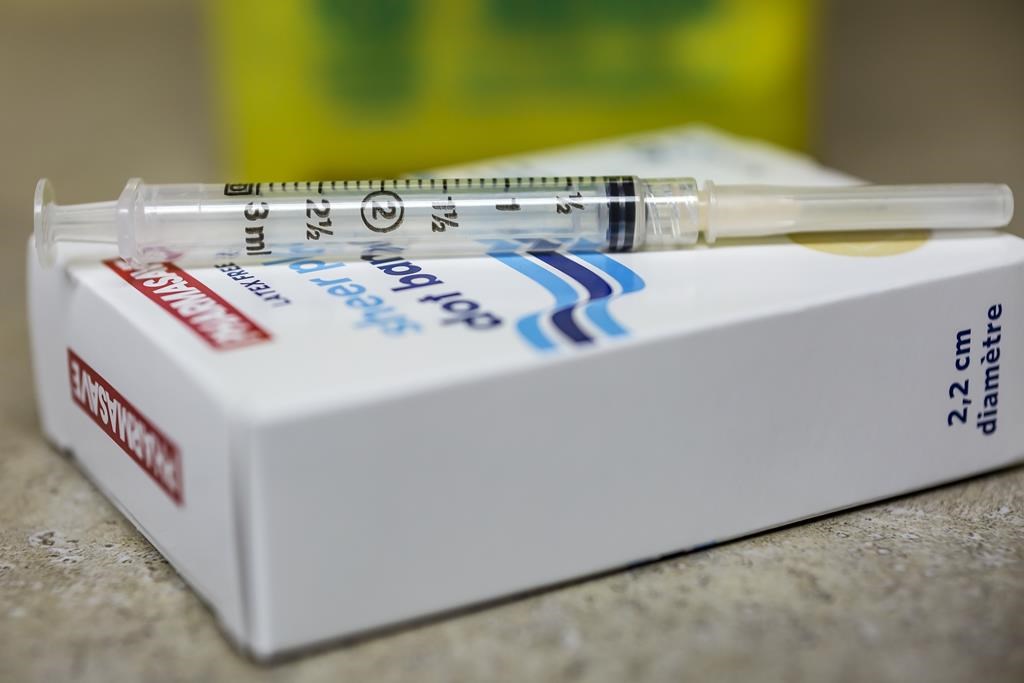 A needle and syringe used to administer the flu shot are shown in Virgil, Ont., Monday, Oct. 5, 2020.