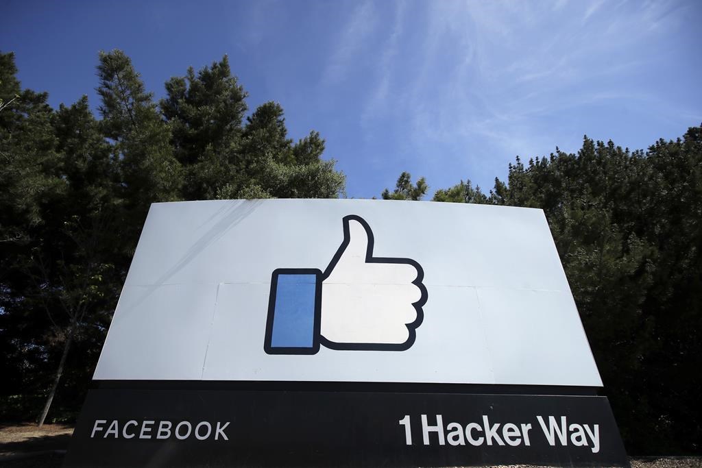 FILE - In this April 14, 2020 file photo, the thumbs up Like logo is shown on a sign at Facebook headquarters in Menlo Park, Calif. Facebook says it plans to hire 10,000 workers in the European Union over the next five years to work on a new computing platform. The company said in a blog post Sunday, Oct. 17, 2021 that those high-skilled workers will help build “the metaverse,” a futuristic notion for connecting people online that uses augmented and virtual reality. (AP Photo/Jeff Chiu, File).