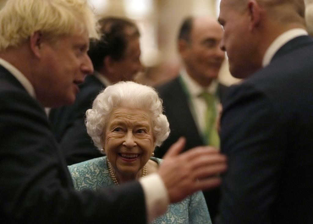 FILE - Britain's Queen Elizabeth II and Prime Minister Boris Johnson, left, greet guests at a reception for the Global Investment Summit in Windsor Castle, Windsor, England, Tuesday, Oct. 19, 2021.