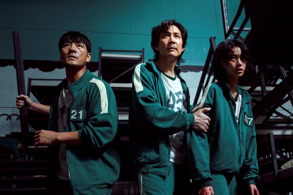 This undated photo released by Netflix shows South Korean cast members, from left, Park Hae-soo, Lee Jung-jae and Jung Ho-yeon in a scene from "Squid Game."