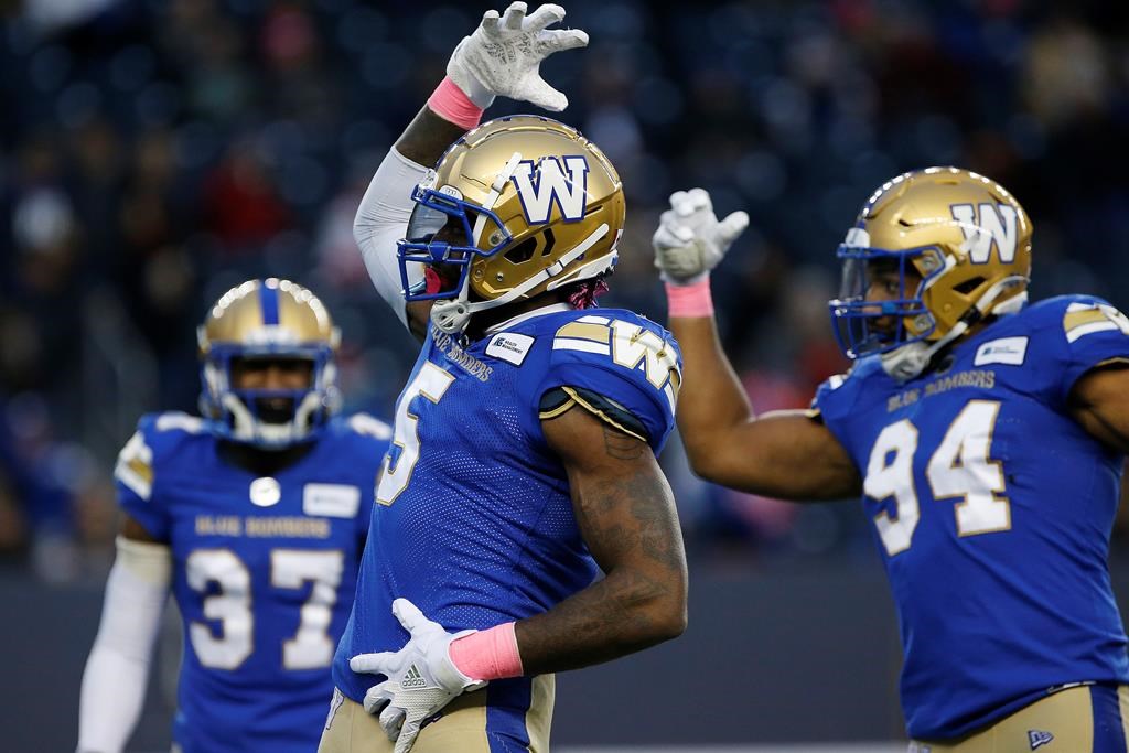 Winnipeg Blue Bombers’ Willie Jefferson (5) and Jackson Jeffcoat (94) celebrate their sack of BC Lions quarterback Mike Reilly (not shown) during the first half of CFL action in Winnipeg Saturday, Oct. 23, 2021.