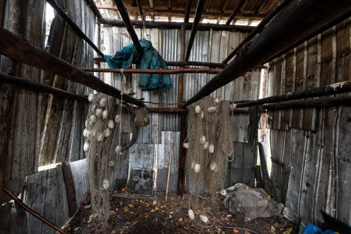 Unused salmon nets hang in the Stevens’ empty smokehouse, which would normally be filled with salmon this time of year, on Wednesday, Sept. 15, 2021, in Stevens Village, Alaska. Two salmon species have all but disappeared from Alaska’s Yukon River this year, prompting the state to shut down fishing in an effort to save them.
