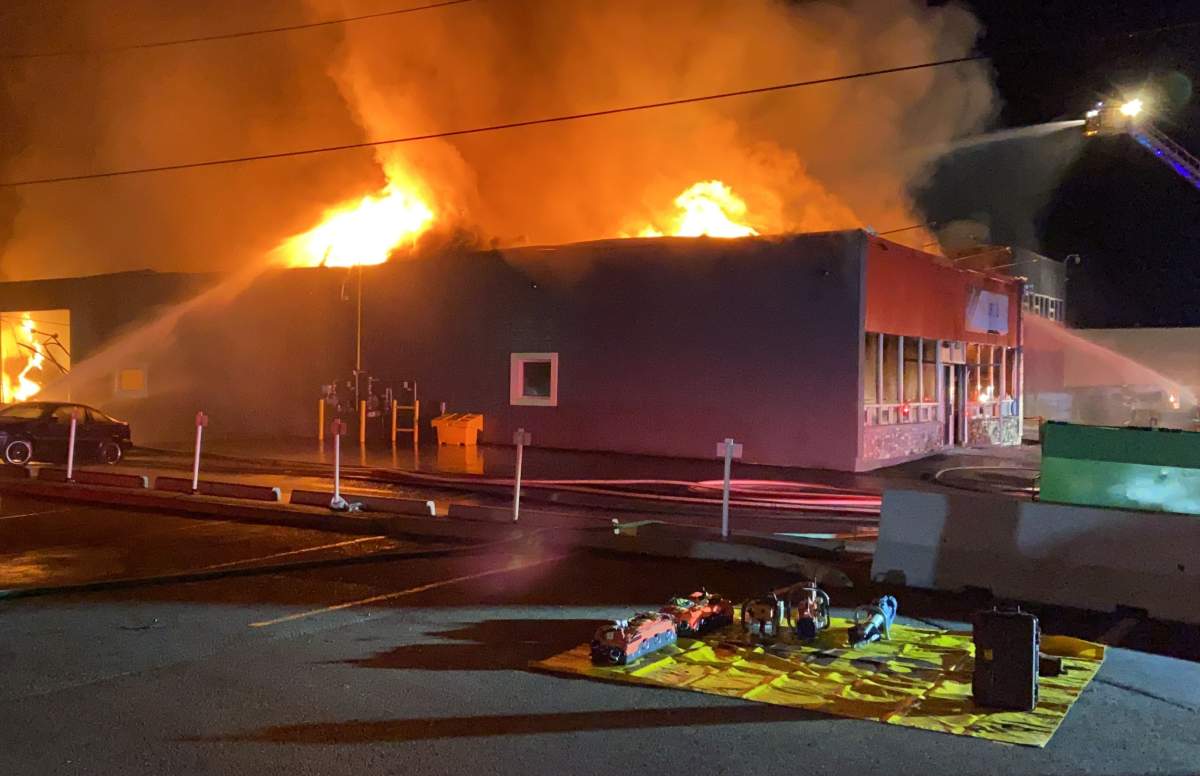 Edmonton firefighters fighting a blaze at a thift shop and non-profit organization near 77 Street and Coronet Road on Friday, October 8, 2021.