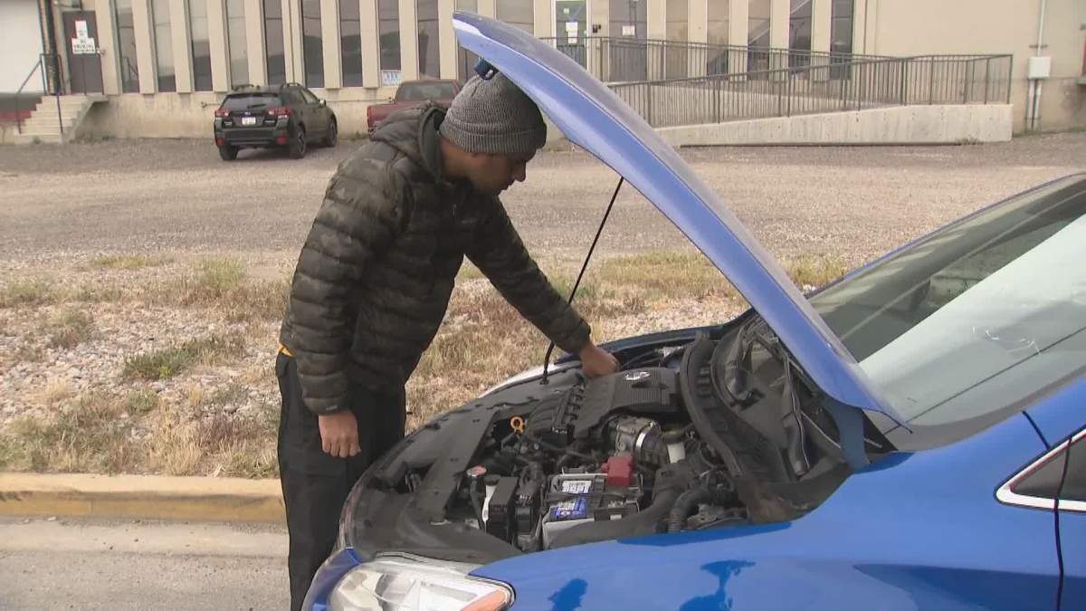 Calgary driver looks over his new “used” vehicle he purchased from Canada Drives