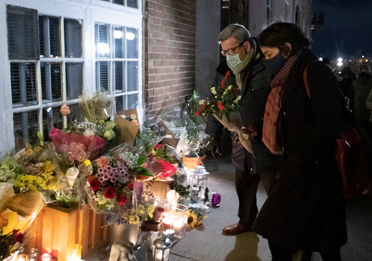 Quebec City mayor Régis Labeaume brings flowers at a vigil to honour Suzanne Clermont who was stabbed to death on Halloween night by a man with a sword, Monday, November 2, 2020  in Quebec City. 