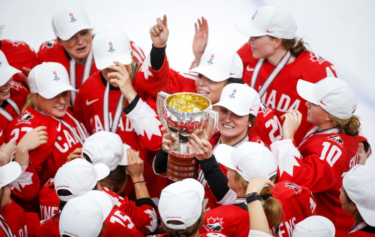 Team Canada's Marie-Philip Poulin, centre, celebrates defeating the United States to win gold at the IIHF Women's World Championship hockey action in Calgary, Tuesday, Aug. 31, 2021.