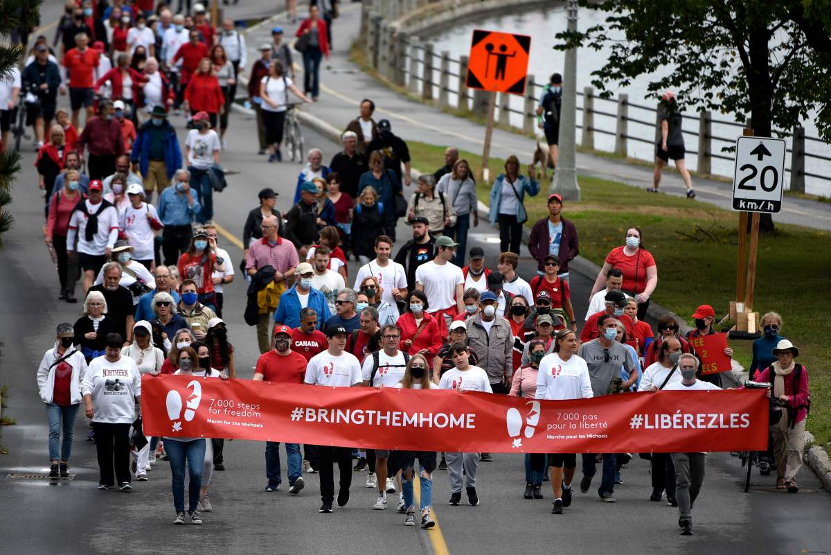 People participate in the March for the Michaels, walking 7,000 steps — the same number of steps Michael Kovrig walks each day in his prison cell — to mark the 1,000 days since Canadians Michael Kovrig and Michael Spavor were detained in China, in Ottawa, on Sunday, Sept. 5, 2021. THE CANADIAN PRESS/Justin Tang