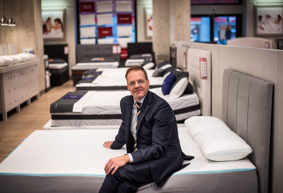 David Friesema, the CEO of Sleep Country Canada, sits on the new "Bloom" mattress, as he poses for a photo at a store in Toronto on Wednesday, May 10, 2017. 
