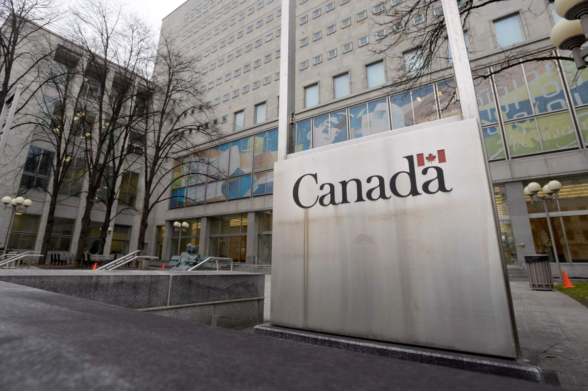 A Government of Canada sign sits in front of a Library and Archives Canada building next to Parliament Hill in Ottawa. The Canadian Historical Association has called on LAC to expand access to its archives during the COVID-19 pandemic.