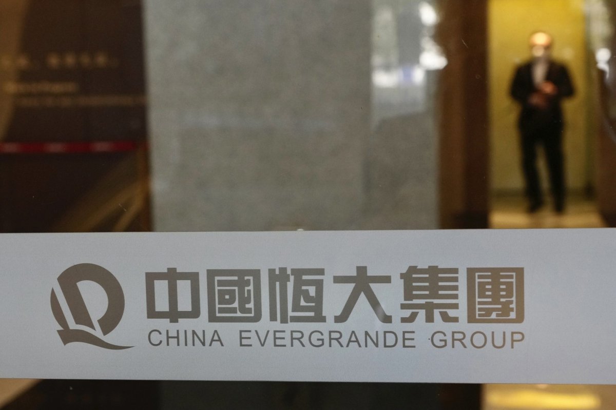 A security guard stands on duty at the headquarters of China Evergrande Group in Hong Kong, Monday, Oct. 4, 2021. Shares in troubled real estate developer China Evergrande Group and its property management unit Evergrande Property Services were suspended from trading Monday in Hong Kong. (AP Photo/Vincent Yu).