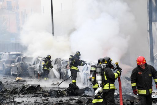 Firefighters work on the site of a plane crash in Milan, Italy, Oct. 3, 2021.