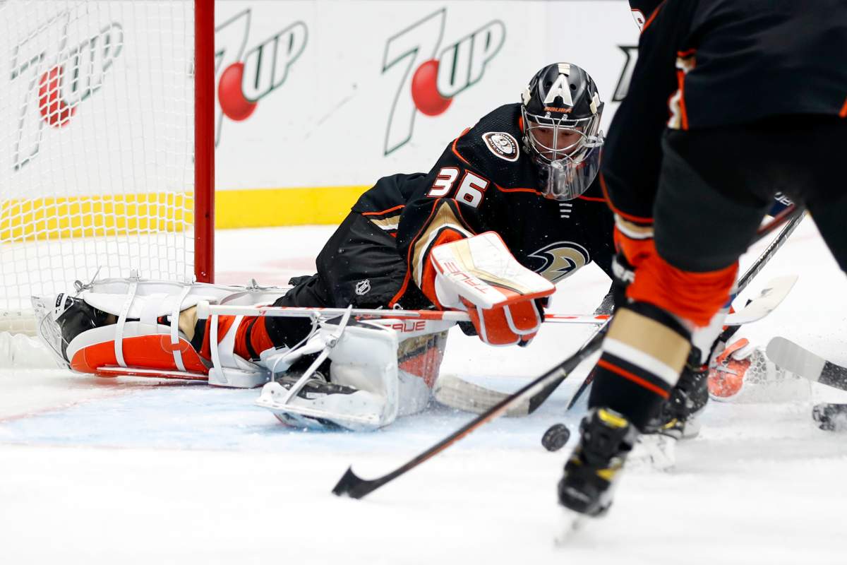 Anaheim Ducks goaltender John Gibson lunges for the puck during the first period of the team’s NHL hockey game against the Winnipeg Jets in Anaheim, Calif., Wednesday, Oct. 13, 2021. (AP Photo/Alex Gallardo)