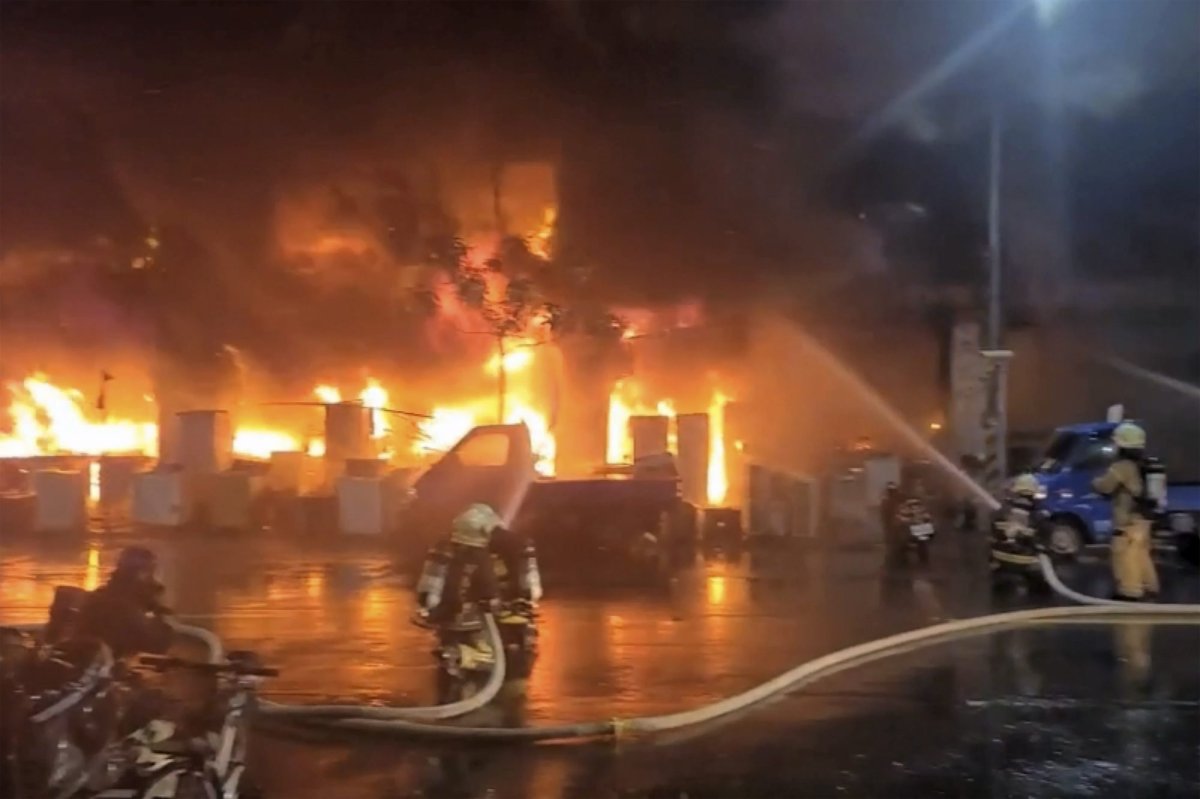 In this image taken from video by Taiwan's EBC, firefighters battle a blaze at a building in Kaohsiung, in southern Taiwan on Thursday, Oct. 14, 2021. The fire engulfed a 13-story building overnight in southern Taiwan, the island's semi-official Central News Agency reported Thursday. (EBC via AP ).