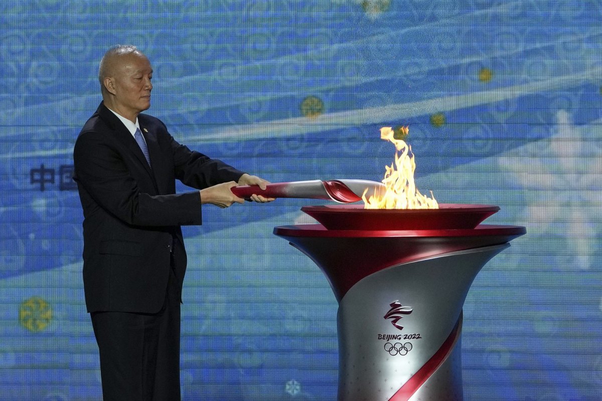Cai Qi, Beijing Communist Party secretary lits up the Olympic cauldron during a welcome ceremony for the Frame of Olympic Winter Games Beijing 2022, held at the Olympic Tower in Beijing, Wednesday, Oct. 20, 2021. A welcome ceremony for the Olympic flame was held in Beijing on Wednesday morning after it arrived at the Chinese capital from Greece. While the flame will be put on display over the next few months, organizers said a three-day torch relay is scheduled starting February 2nd with around 1200 torchbearers in Beijing, Yanqing and Zhangjiakou. (AP Photo/Andy Wong).