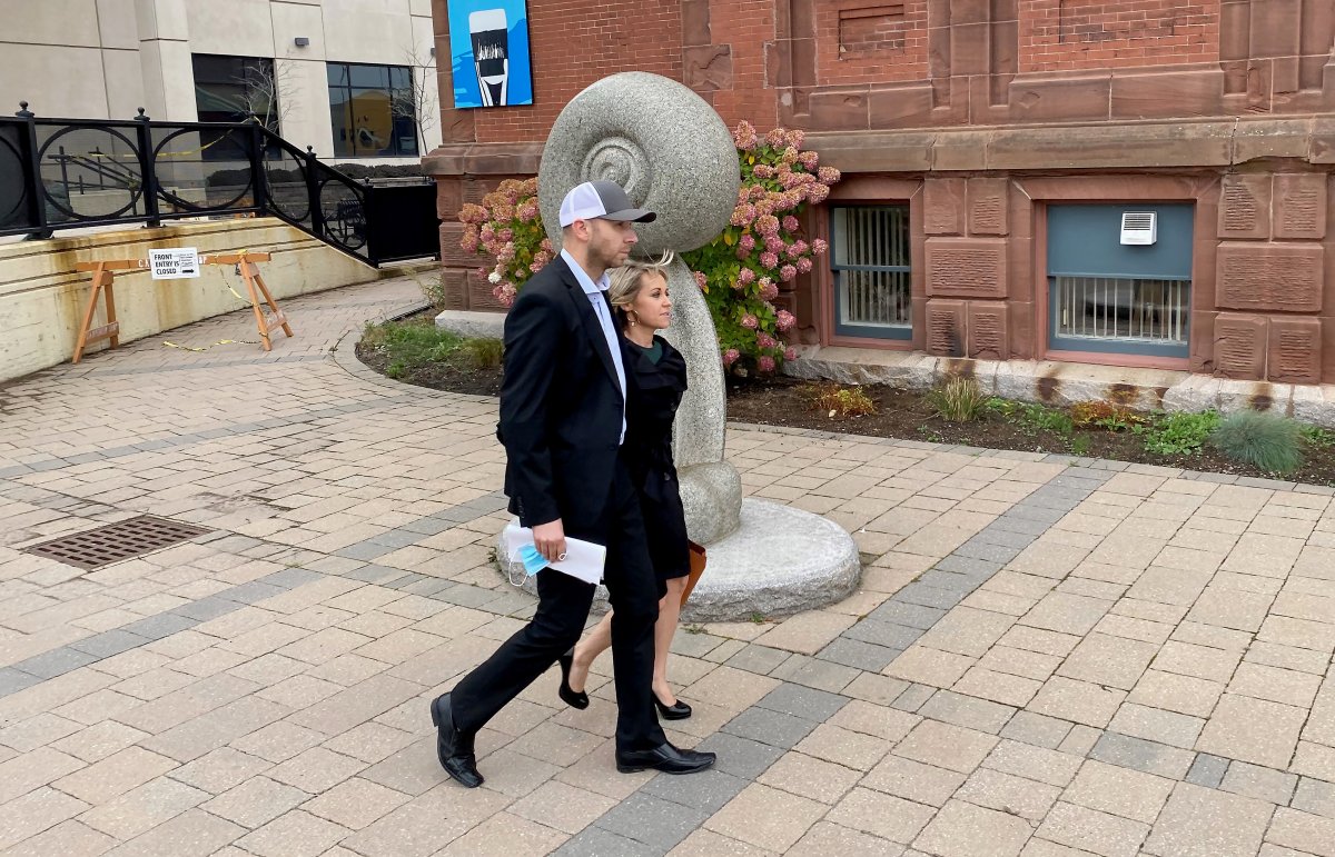 Pastor Philip Hutchings, left, and his wife Jamie Hutchings leave the Courthouse in Saint John, N.B., Friday, Oct. 22, 2021. Hutchings, a New Brunswick pastor, is free after spending a week in jail and apologizing to the courts for alleged breaches of COVID-19 public health rules. THE CANADIAN PRESS/Kevin Bissett.