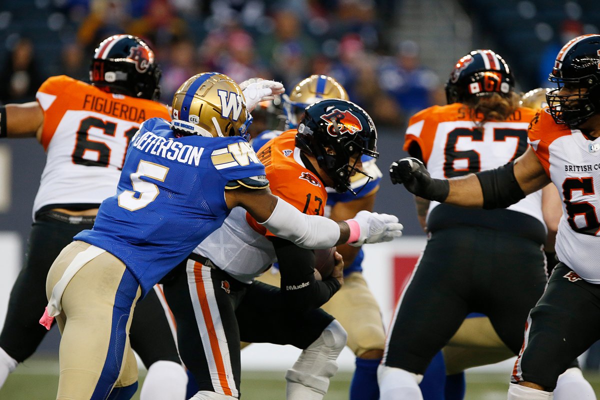 Winnipeg Blue Bombers' Willie Jefferson (5) sacks B.C. Lions quarterback Mike Reilly (13) during the first half of CFL action in Winnipeg Saturday, October 23, 2021.