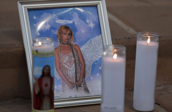 FILE - Candles are placed next to a photograph of cinematographer Halyna Hutchins during a vigil in her honor in Albuquerque, N.M. Saturday, Oct. 23, 2021.