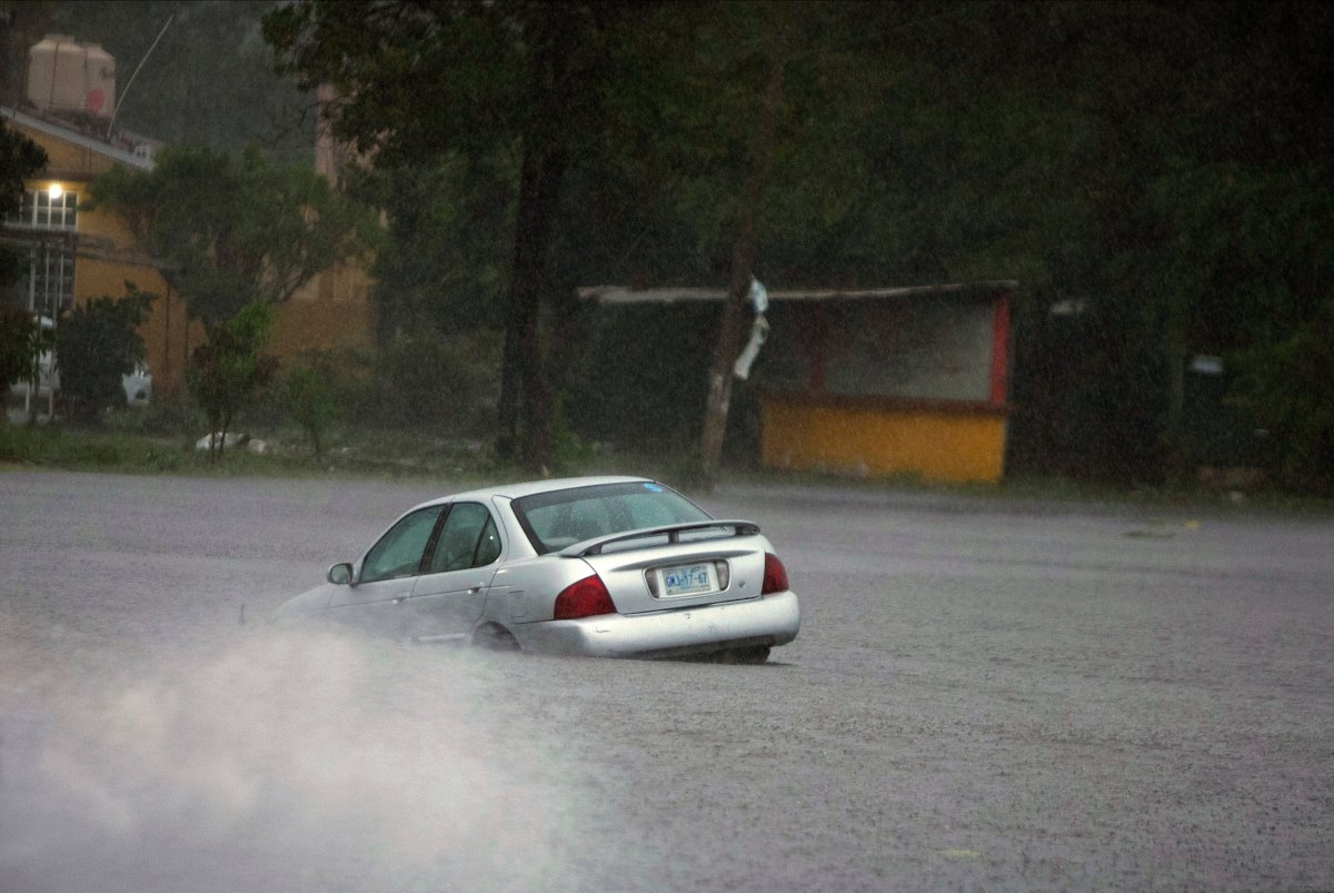 A car is stuck in a flooded street due to Hurricane Rick in Lazaro Cardenas, Mexico, Oct. 25, 2021.