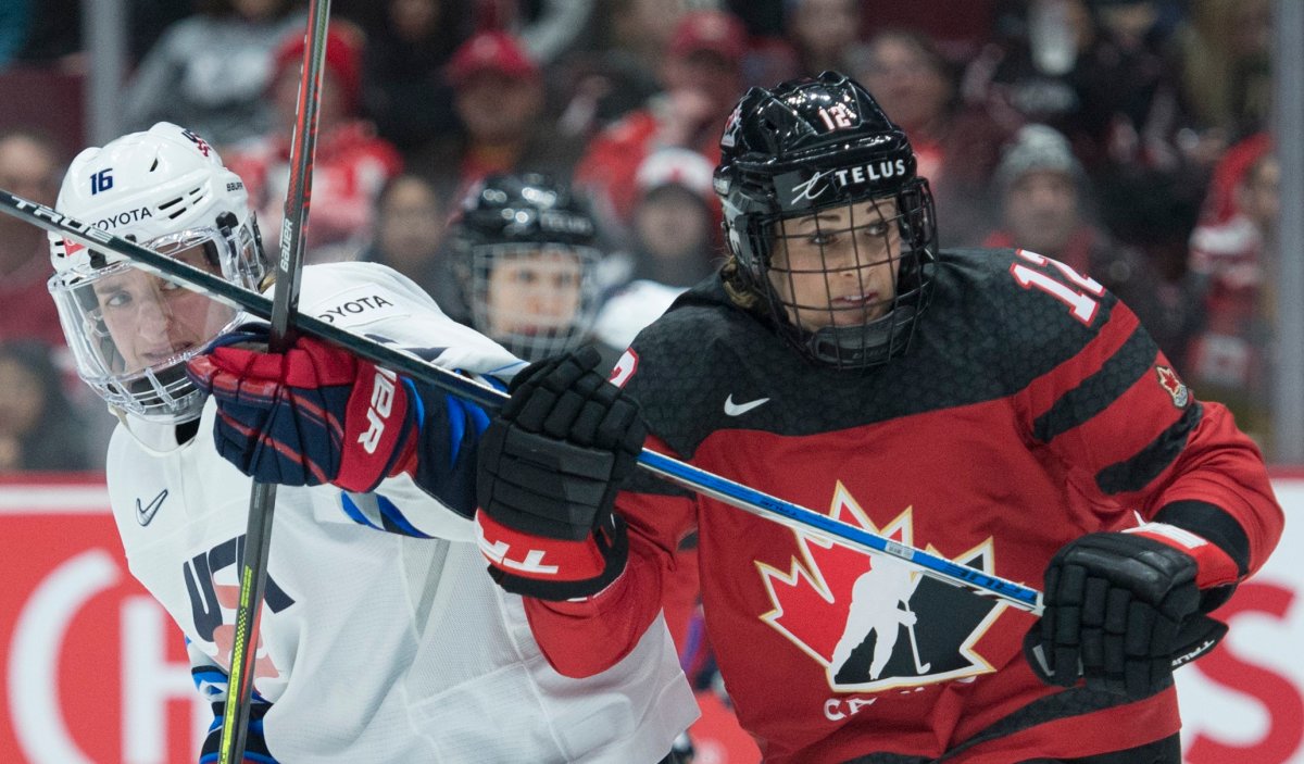 Team Canada's Meaghan Mikkelson fights for control of the puck with U.S.A.'s Hayley Scamurra during third period of Women's Rivalry Series hockey action in Vancouver, Wednesday, February 5, 2020. 