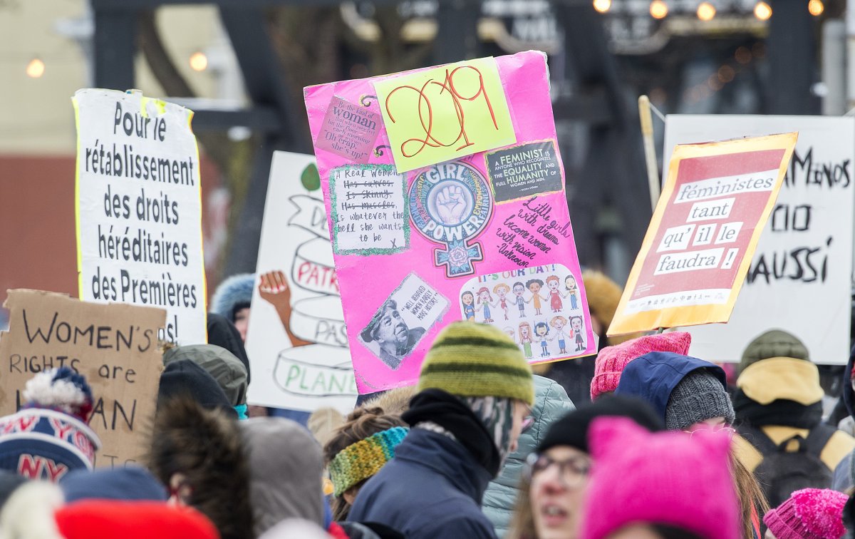 People hold up signs during the Women's March in Montreal, Saturday, January 19, 2019. 