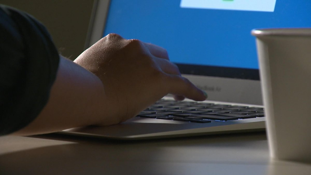 File: A person typing on a laptop.