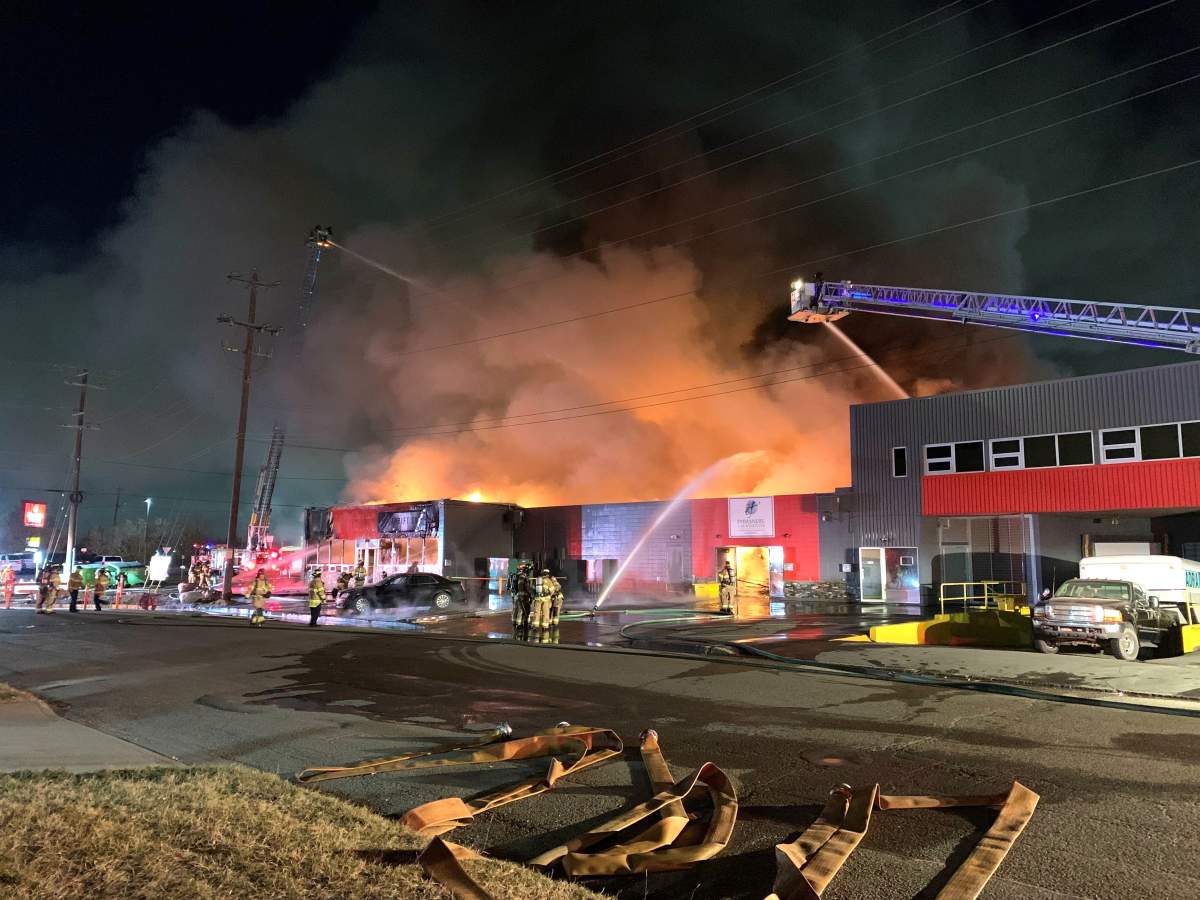 Edmonton firefighters fighting a blaze at a thift shop and non-profit organization near 77 Street and Coronet Road on Friday, October 8, 2021.