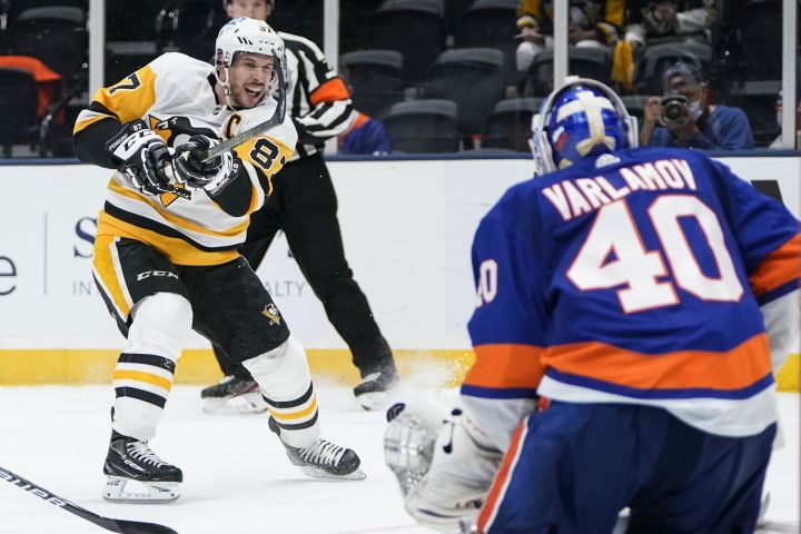 New York Islanders goaltender Semyon Varlamov (40) stops a shot by Pittsburgh Penguins’ Sidney Crosby (87) during the third period of Game 3 of an NHL hockey Stanley Cup first-round playoff series Thursday, May 20, 2021, in Uniondale, N.Y. The Penguins won 5-4.