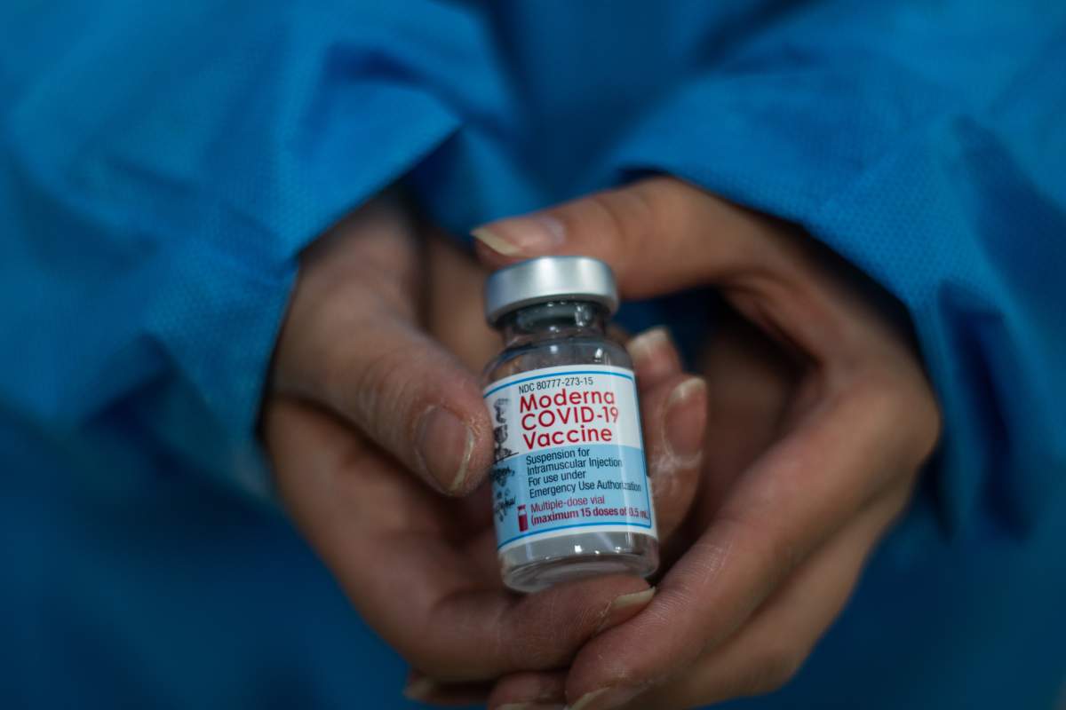 A nurse shows the vial of the Moderna novel Coronavirus vaccine as public transport drivers and people from ages 25 to 30 start their vaccination phase with the Moderna novel COVID-19 vaccine against the Coronavirus disease in Bogota, Colombia on August 2, 2021. (Photo by:Ximena Rubio/Long Visual Press/Universal Images Group via Getty Images).
