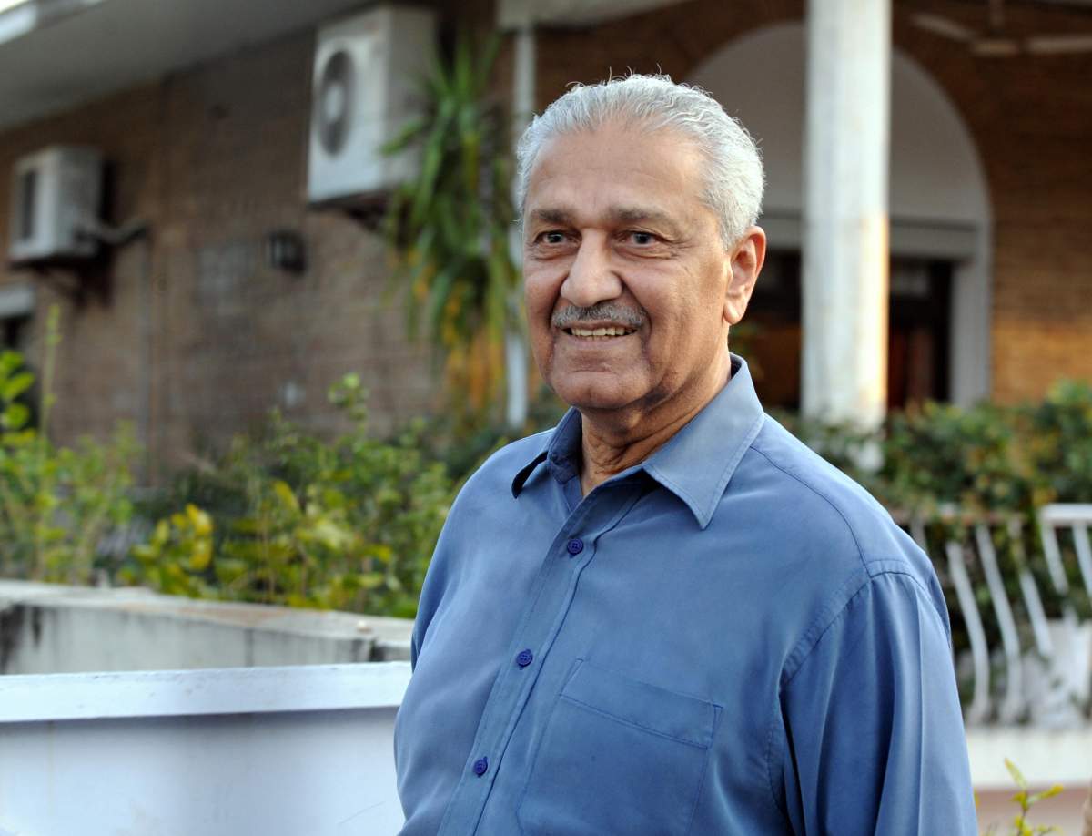 Pakistani nuclear scientist Abdul Qadeer Khan waves as he walks in a garden in Islamabad on February 7, 2009.