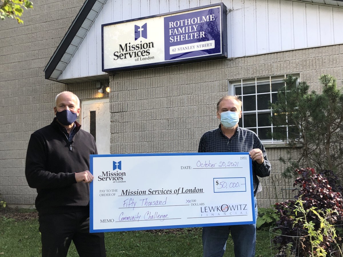 Robert Lewkowitz, owner of Lewkowitz Financial with Mike Toth, director of shelters, donating $50,000 to Mission Services of London on Oct. 20, 2021.