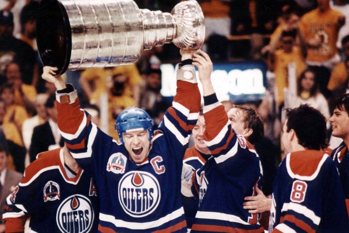 Edmonton Oilers’ captain Mark Messier, center, along with his teammates holds the Stanley Cup above his head in voctory after the Edmonton Oilers defeated the Boston Bruins, 4-1, to win the Stanley Cup series in Boston May 1990.