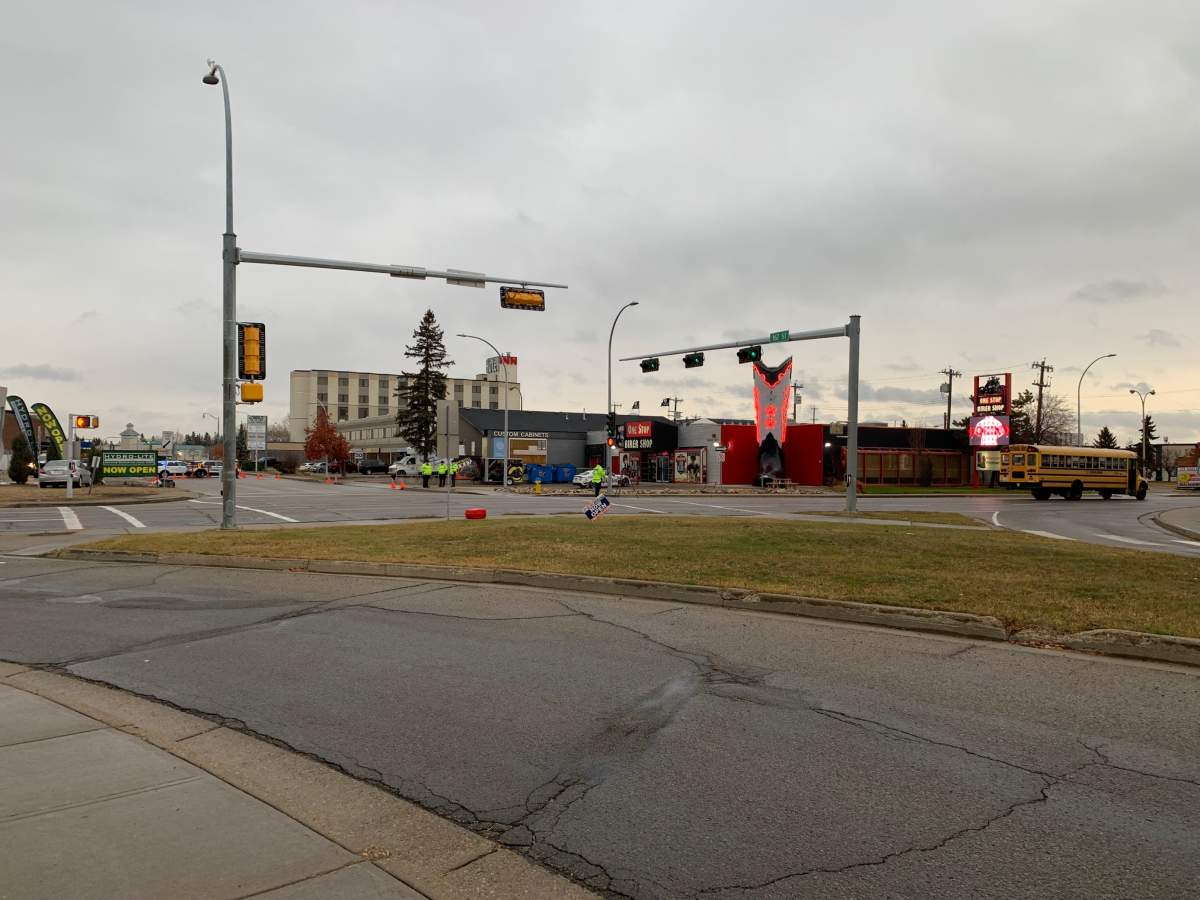 A pedestrian collision involving a teenage girl and a school bus shut down 100 Avenue near 167 Street in west Edmonton on Monday, Oct. 25, 2021.