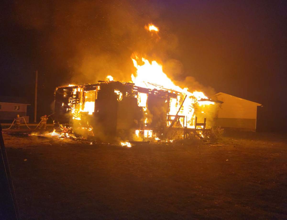 Photo of the house engulfed in flames.