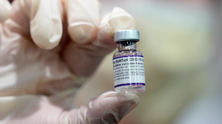  A healthcare worker holds a vial of the Pfizer COVID-19 vaccine. 