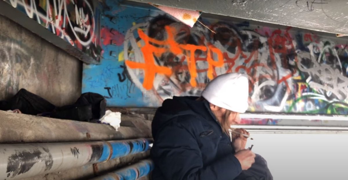 Tim, a Penticton man experiencing homelessness, is pictured smoking speed underneath a Penticton bridge to 'fight off the cold.' .