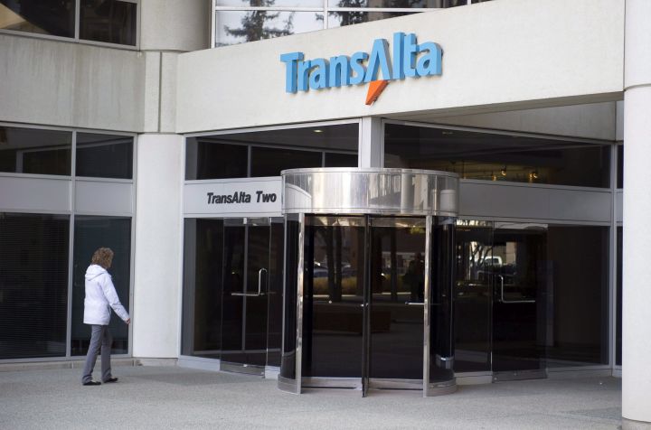 A woman walks towards the entrance of the TransAlta headquarters building in Calgary on April 29, 2014. 