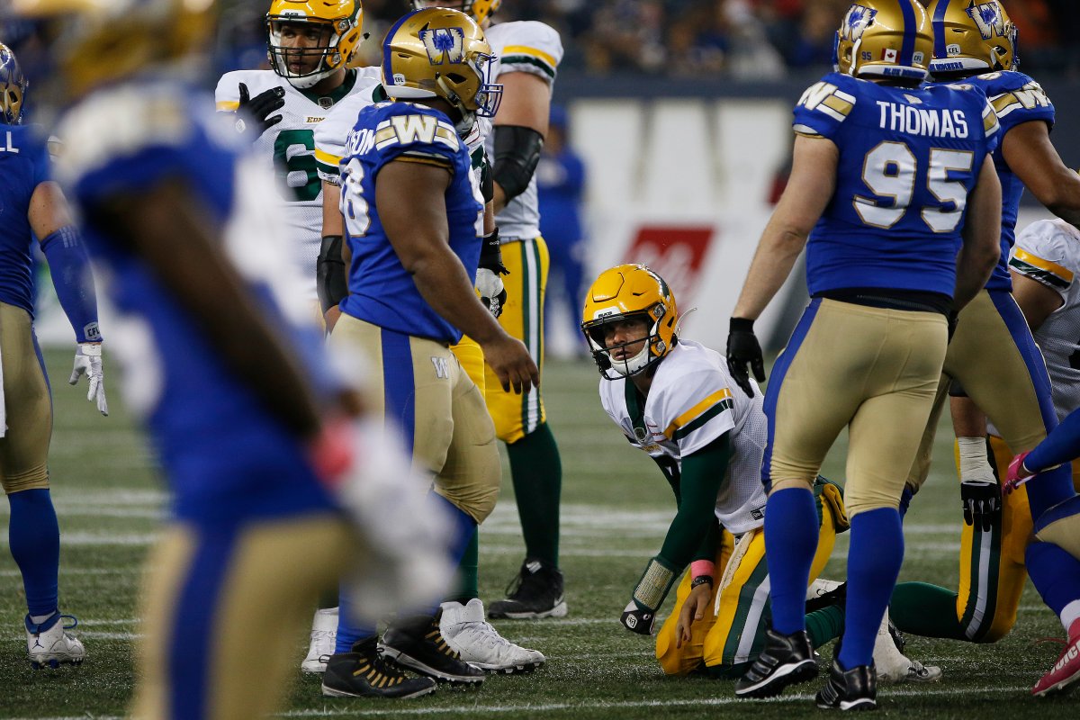 Edmonton Elks quarterback Trevor Harris (7) looks up after getting sacked by the Winnipeg Blue Bombers during the second half of CFL action in Winnipeg Friday, Oct. 8, 2021.   