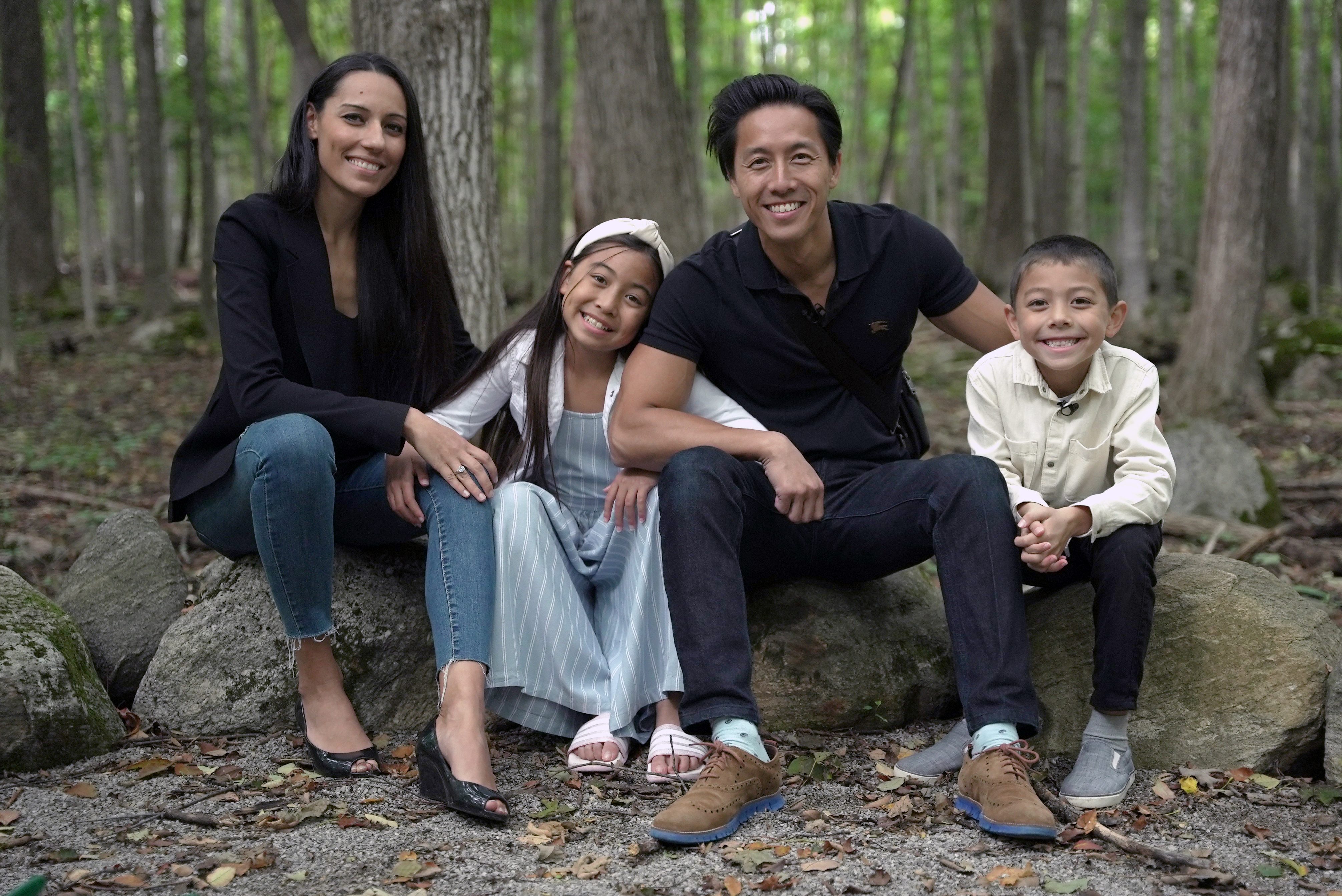 Workplace culture consultant Andrew Au pictured with his wife and two children