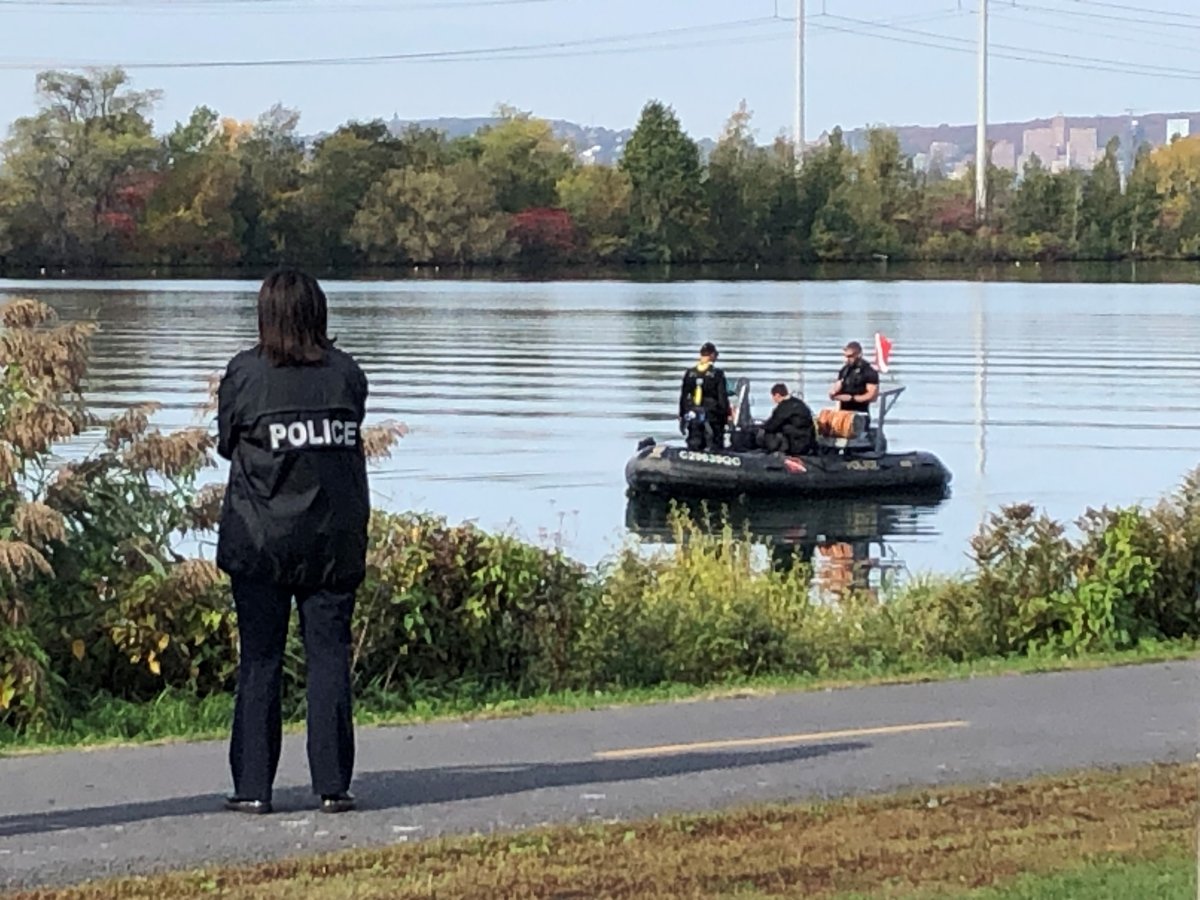 Police search the waterfront in Brossard for a missing man on Tuesday, Oct. 12, 2021.