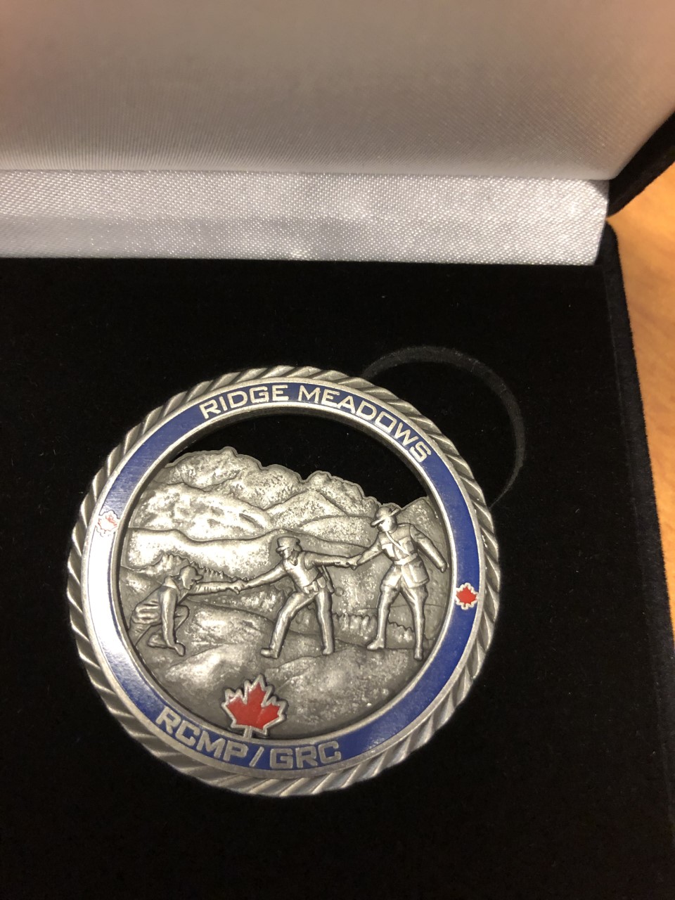 A photo of the coin presented to each of the five men.