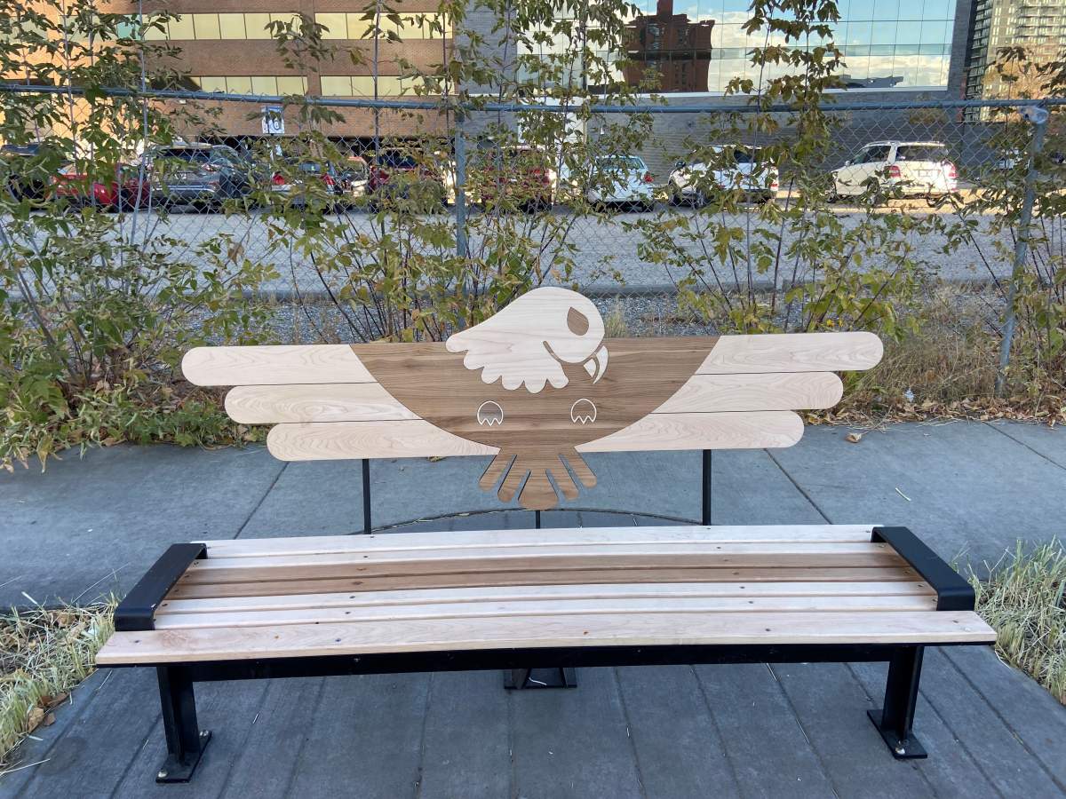 Bench beside sculpture.