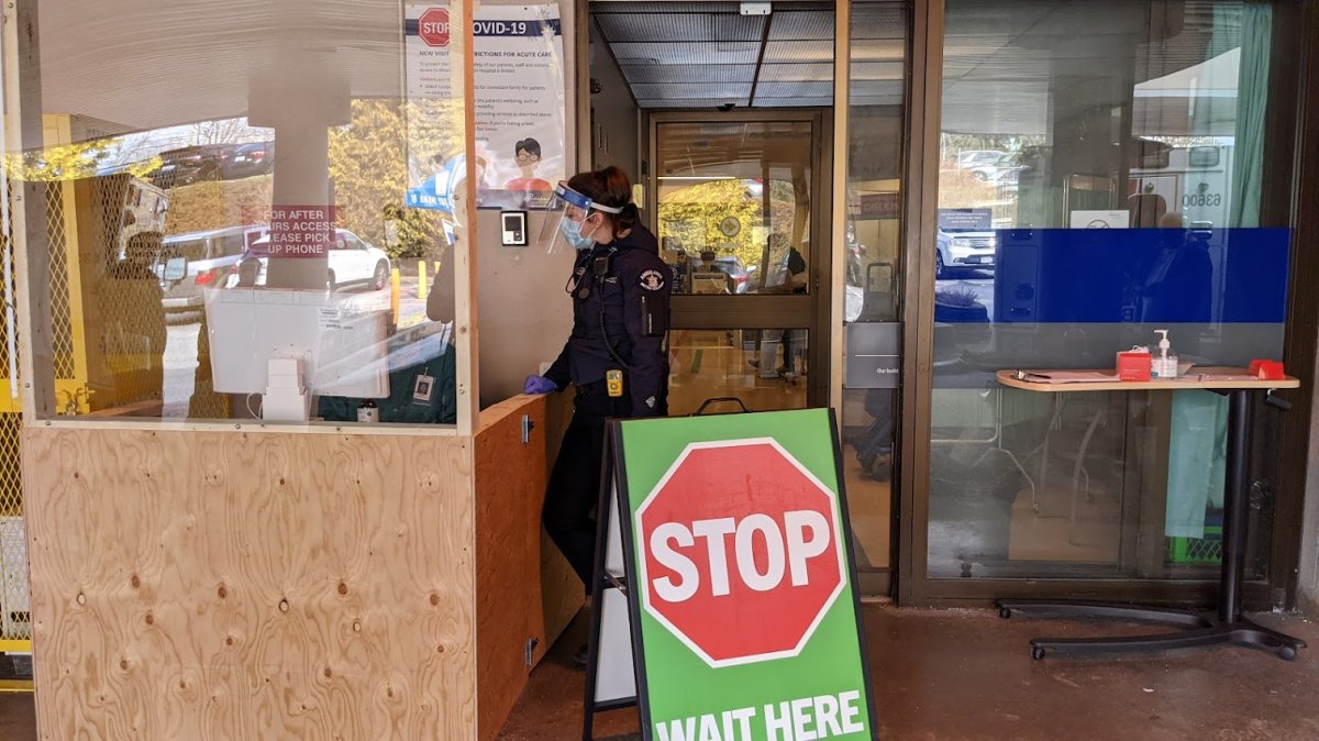 A paramedic waits outside a COVID-19 safety control point outside Mount St. Joseph Hospital in Vancouver, B.C.