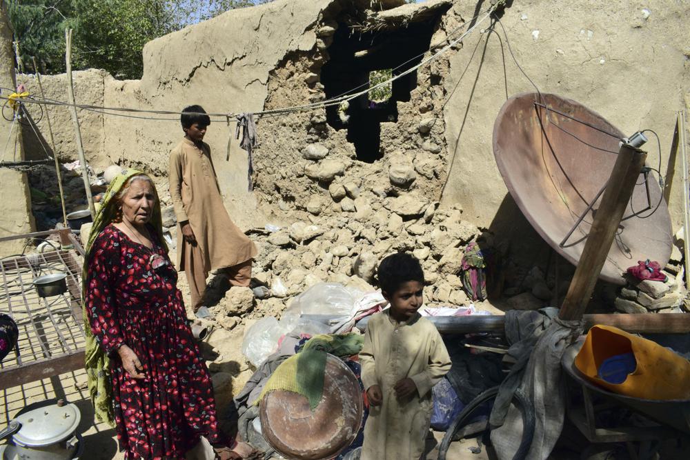 A family is seen inside their house following an earthquake in Harnai, about 100 kilometers (60 miles) east of Quetta, Pakistan, Thursday, Oct. 7, 2021. The powerful earthquake collapsed at least one coal mine and dozens of mud houses in southwest Pakistan early Thursday. (AP Photo/Arshad Butt)
.