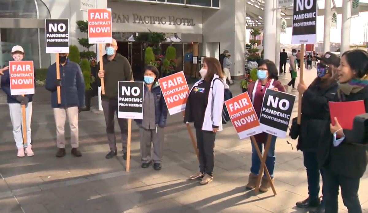Housekeepers, union organizers and their supporters rally outside the Pan Pacific Vancouver on Oct. 19, 2021. They allege they were fired during the pandemic based on their sex and race.