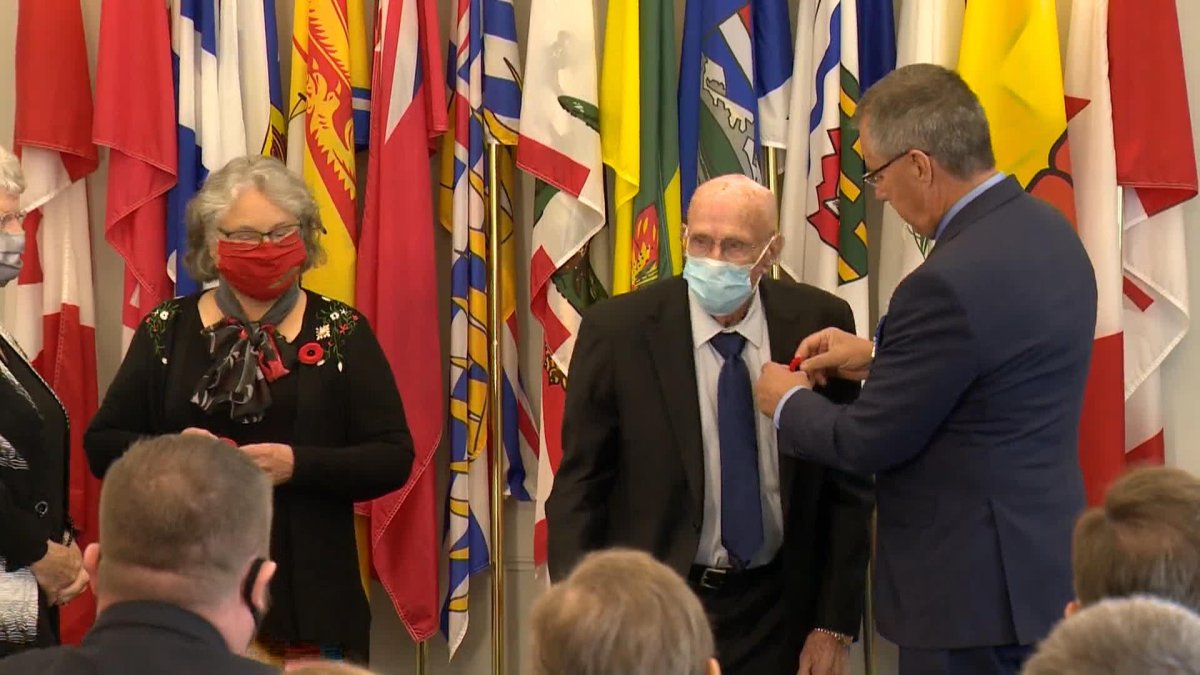 Margaret Schaffer and Tom Jenkins, the niece and nephew of Lance Corporal Morgan Jones Jenkins, received their poppies from Saskatchewan’s lieutenant-governor.
