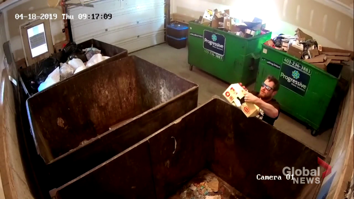 Robert Leeming throws out garbage in his Calgary condo complex on April 18, 2019.