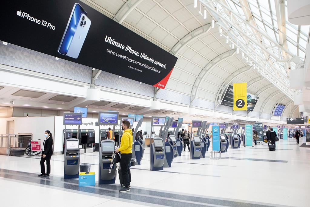 A passenger checks in at Toronto's Pearson Airport on Friday, Oct. 29, 2021. 