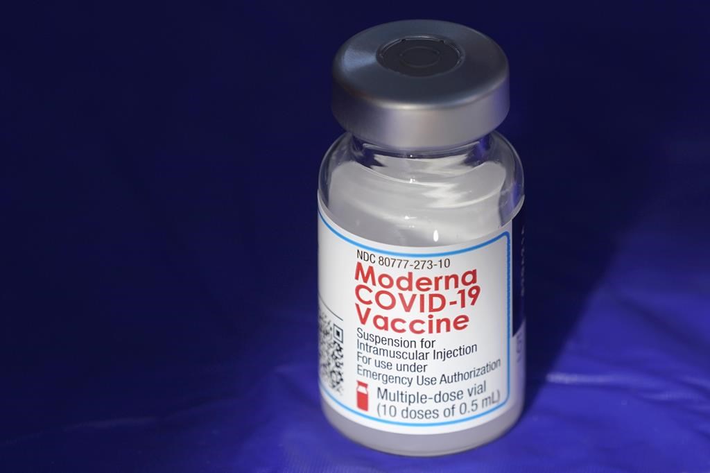 FILE - In this March 4, 2021 file photo, a vial of the Moderna COVID-19 vaccine rests on a table at a drive-up mass vaccination site in Puyallup, Wash., south of Seattle. Moderna is scaling back expectations for the number of COVID-19 vaccine deliveries it expects to make this year. The drugmaker said Thursday, Nov. 4, that longer delivery lead times for exports and a temporary impact from expanding its fill-finish capacity may shift some deliveries to early 2022.