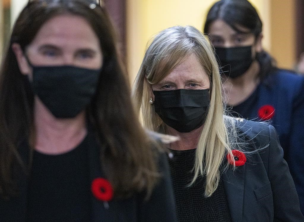 Tracy Kitch, centre, the former chief executive of the IWK Health Centre, a children's hospital, heads from provincial court during a break in Halifax on Monday, Nov. 8, 2021.